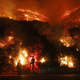 Firefighters monitor a section of the Thomas Fire along the 101 freeway this morning. (Photo: Mario Tama/Getty Images.)